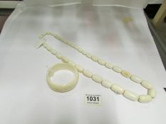 An ivory necklace and an ivory bracelet