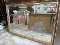 A gilt framed etched mirror