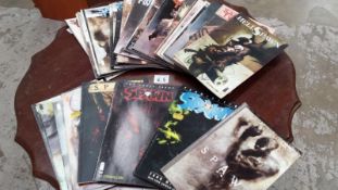 A collection of Spawn graphic novels and