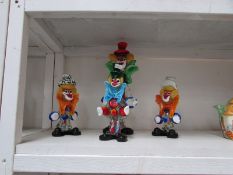 4 coloured glass clowns