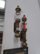 A pair of brass candle wall lamps stampe