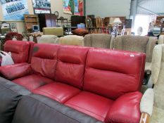An electric red leather sofa and matchin