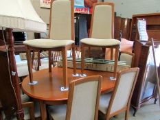 A teak dining table and 6 chairs
