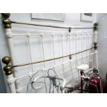 A 6ft (180cm) wide brass and iron bedste