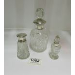 3 silver topped perfume bottles