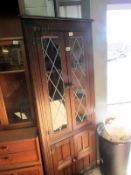 An oak corner cabinet with lead glazed d