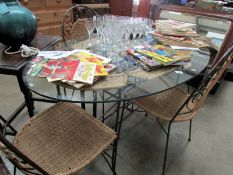A glass topped dining table and 4 chairs