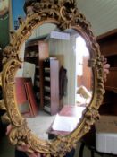 A gilt framed oval mirror