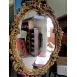 A gilt framed oval mirror