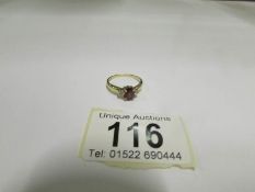 A 9ct yellow gold garnet ring, size L