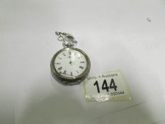 A silver fob watch (hand loose but in wo