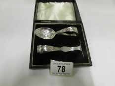 A cased silver spoon and pusher dated Bi