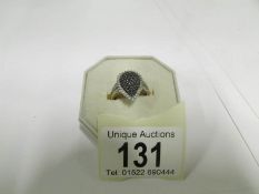 A yellow gold ring set black and white d