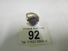 An Australian black opal ring set with d
