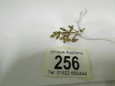 A gold brooch set seed pearls (marked 15