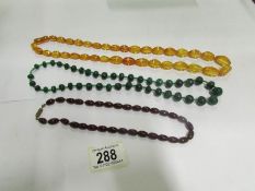 An amber necklace and 2 others