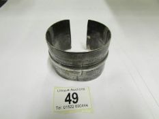 An unusual cuff bracelet in silver colou