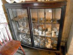 A Victorian display cabinet on ball & cl