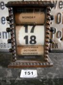 A oak cased desk calendar