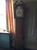 A long case clock with brass face