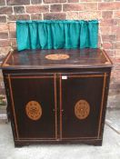 A Victorian inlaid cabinet with curtain