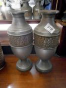 A pair of metal vases