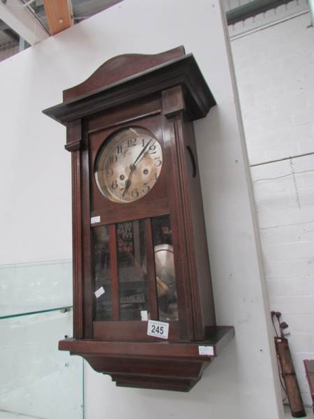 An Edwardian oak wall clock