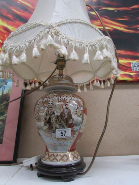 An Oriental style table lamp with shade