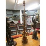 A tall ornate gilded table lamp