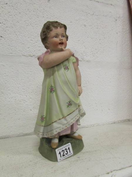 A bisque porcelain figure of a girl