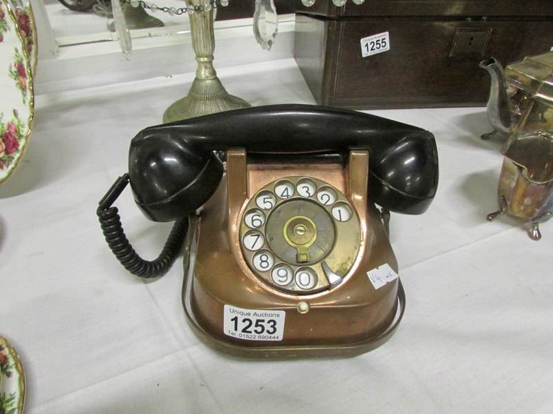 A vintage copper telephone