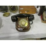 A vintage copper telephone