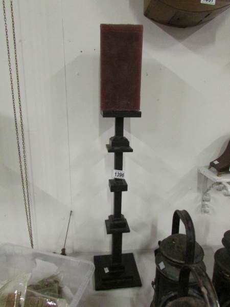 A cast iron candleholder with candle