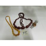 An Amber necklace, a white metal bracele