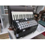 A cased piano accordian