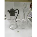 A claret jug with pewter top and one oth