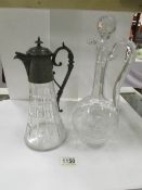 A claret jug with pewter top and one oth