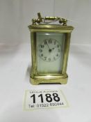 A miniature brass carriage clock