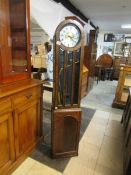 An oak long case clock with electric mov