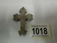 A white metal cross pendant marked MIZPA
