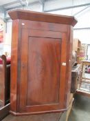 A mahogany corner cupboard