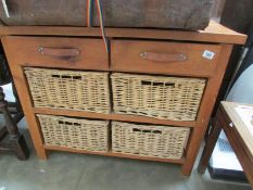 A Pine and wicker bathroom chest