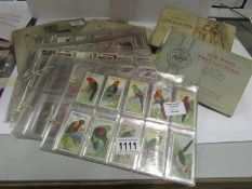 A collection of cigarette cards includin