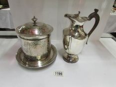 A silver plated biscuit barrel and jug