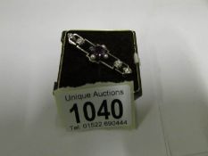 An amethyst and pearl set brooch stamped