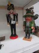 2 nut cracker figures of a soldier and a