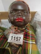 A black porcelain headed doll marked 'He