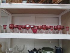 A quantity of cut cranberry glass drinki