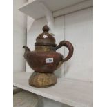 A large urn/lidded teapot in middle east