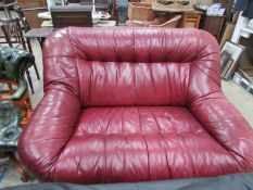 A tan leather 2 seat sofa